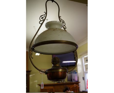 A brass and copper hanging oil lamp, with opaque glass shade.&nbsp; 