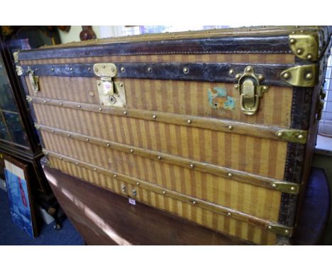 A circa 1885 Louis Vuitton full size travelling trunk,&nbsp;with striped fabric exterior, the brass clasp stamped 'Louis Vuit