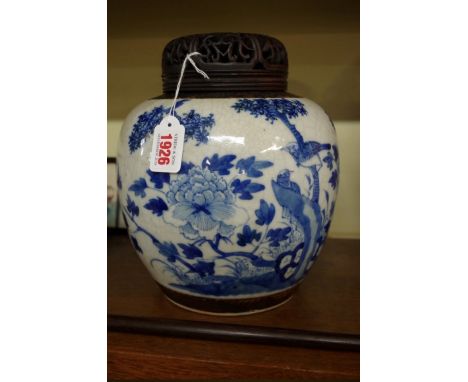 A Chinese crackle glaze blue and white ginger jar,&nbsp;Kangxi four character mark,&nbsp;21.5cm high, with pierced hardwood c
