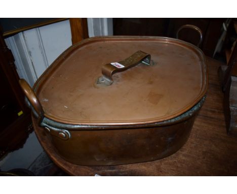 An old copper twin handled turbotiere and cover, with broad arrow stamp, 56cm wide.&nbsp; 