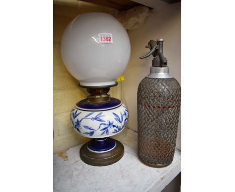 A vintage pottery and brass oil lamp; together with a vintage soda syphon.&nbsp; 