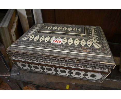 A 19th century Vizagapatam sewing casket,&nbsp;the interior lid panel painted with a watercolour landscape, 33cm wide. 