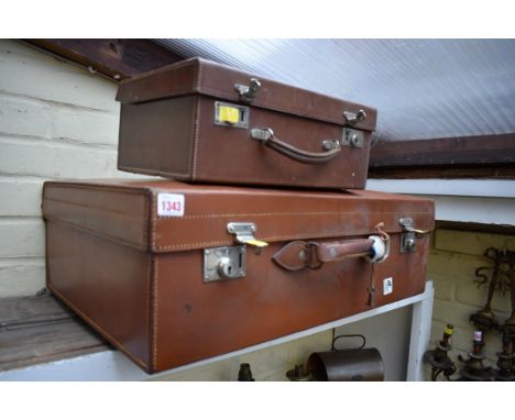 A vintage brown leather suitcase, by Finnigans 65cm wide; together with another smaller example. 
