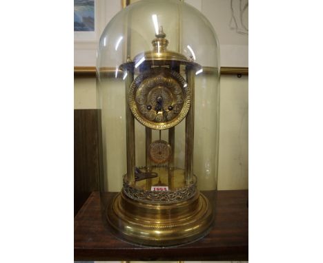 A brass mantel clock, 39cm high, with associated glass dome.&nbsp; 