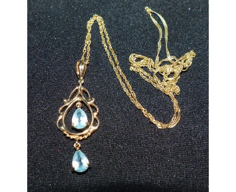 A 9 carat hallmarked gold pendant set with light blue stones, stamped '375', 2 gm