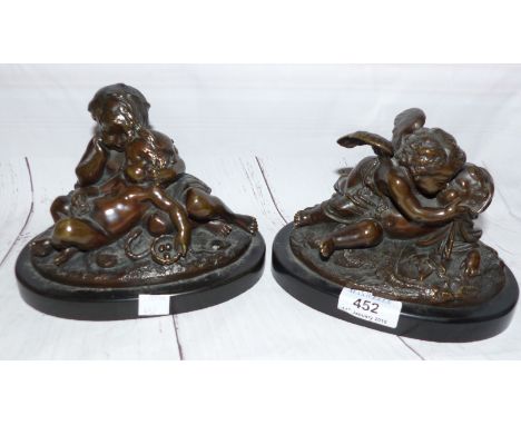 A pair of 19th century bronze figure groups, children with putto, oval black marble bases, overall width 7"