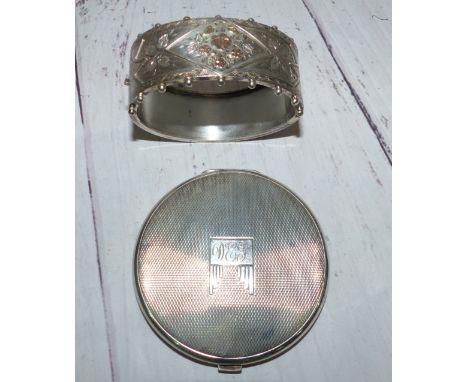 A silver Victorian style stiff hinged bracelet; a silver cased powder compact