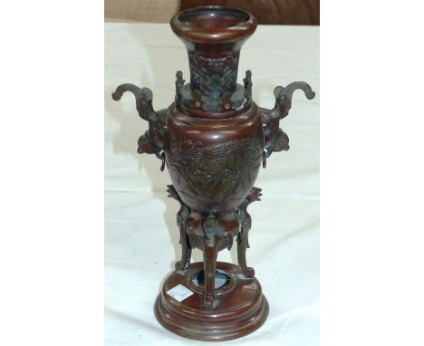 An oriental bronze urn on stand, 10½"