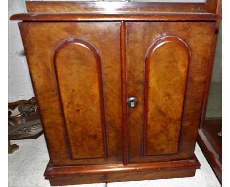 A 19th century miniature cabinet with 3 internal drawers enclosed by 2 panel doors