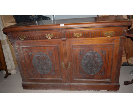 An Edwardian mahogany sideboard base with 2 drawers and 2 carved panel doors
