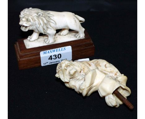 A late 19th/early 20th century carved ivory walking stick handle in the form of a tiger; a similar lion on plinth