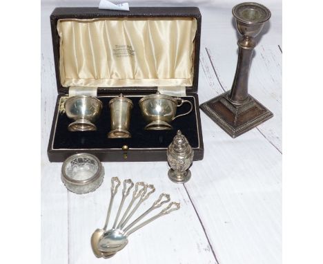 A silver 3 piece cruet set, cased; a candlestick; a set of silver coffee spoons; a pepper and a glass salt
