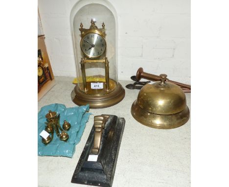 A large brass table bell; a 400 day clock under glass dome; a brass fender and doorstop