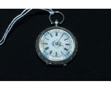 An Edwardian chased white metal pocket watch, key wound and open faced, the white enamel dial with painted and gilded decorat