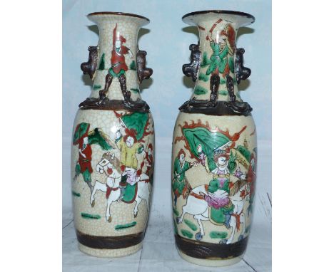 A pair of mid-20th century Chinese crackle glaze baluster vases decorated in polychrome with warriors, height 12" (hairline c