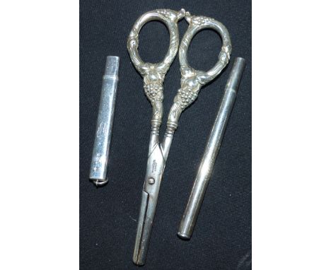 A pair of steel and white metal grape scissors, handles stamped 'STERLING'; a Wincarnis thermometer holder