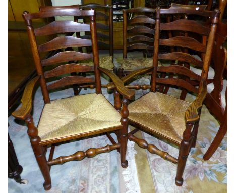 A set of 8 (6 + 2) elm country made dining chairs with ladder backs and rush seats, on club legs