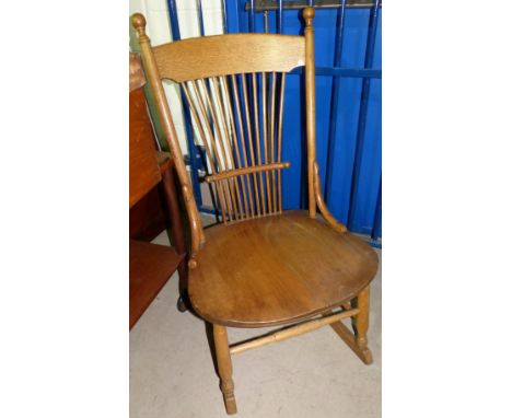 A light oak stick back rocking chair