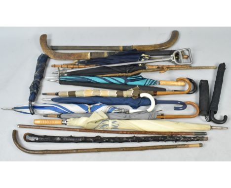 A Collection of Various Vintage Walking Sticks, Shooting Stick, Umbrellas and Two Hockey Sticks