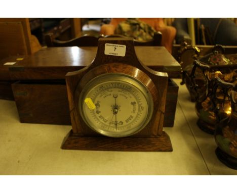 An early 20th Century oak cased barometer 