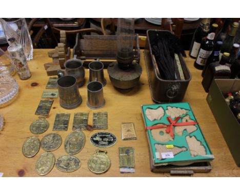 An oak extending book rack; a pair of book ends; various brass plaques; pewter tankards; oil lamp; wooden Christmas decoratio