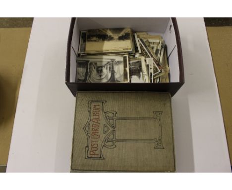 A box containing a post-card album and collection of loose post-cards 