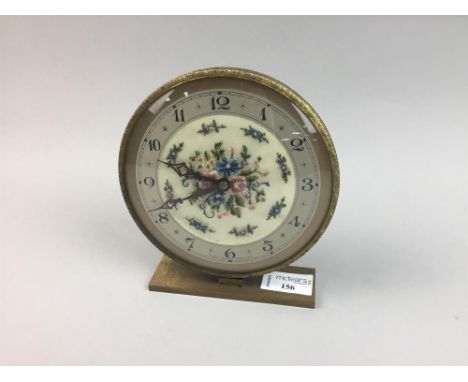 ALARM CLOCK, the round dial with Arabic numerals and floral tapestry decoration, 17.5cm high