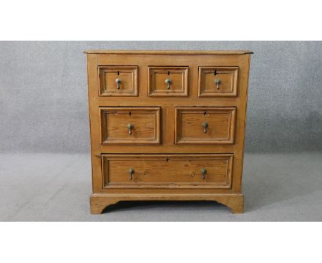 An 18th century pine chest, with a plank top above three short, over two short, over one long drawers, the sides of paneled c