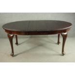 A Victorian mahogany extending wind-out dining table, of oval form, with an additional lead and a