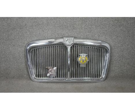 A vintage polished chrome MG car grille, with attached AA badge and MG Car Club badge. H.39 W.68cm 