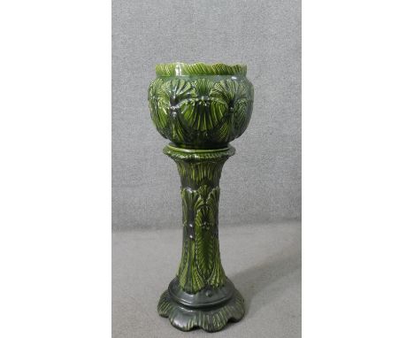 A Victorian green glazed majolica sea shell design planter with matching pedestal base. Impressed marks. H.94 W.35cm (on stan