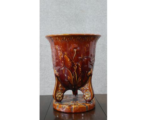 An Art Nouveau treacle glaze majolica planter with relief floral and foliate design. Impressed makers mark to the base. H.36 