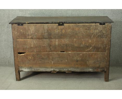 An 18th century oak mule chest, with a plank top over a fielded panel front, above three short drawers, on bracket feet. H.72