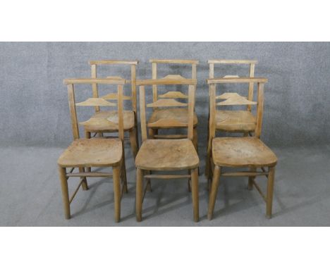 A set of six 19th century rustic pine kitchen chairs, with ladder back, over an elm seat, the legs joined by stretchers. 