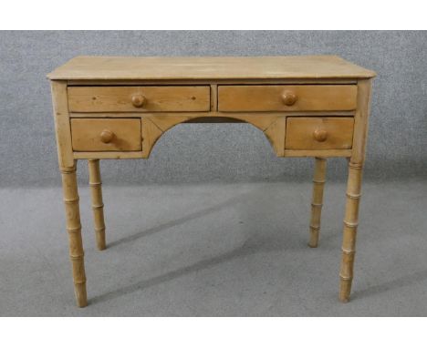 A Victorian pine kneehole desk, with an arrangement of four drawers with knob handles, on simulated bamboo legs. H.72 W.90 D.