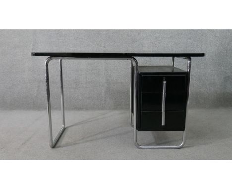 A Marcel Breuer style tubular chromed desk, with an ebonised rectangular top over an ebonised pedestal of three drawers with 