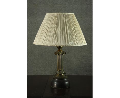 A 20th century brass Ionic column table lamp, with an ivory pleated shade. H.60 W.40cm. 