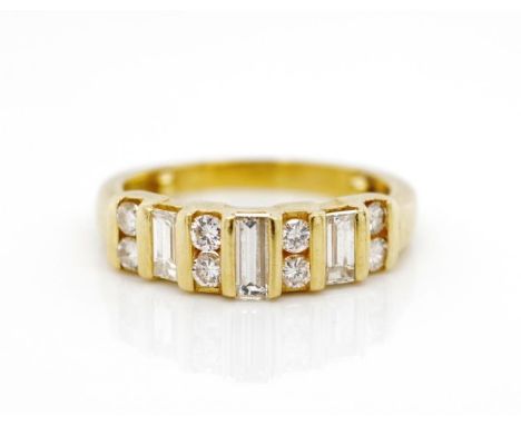 Diamond set 18ct yellow gold ring channel set with 8x round brilliant cuts and 3x baguette cut diamonds.  Marked 18ct. Approx
