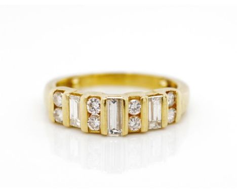 Diamond set 18ct yellow gold ring channel set with 8x round brilliant cuts and 3x baguette cut diamonds.  Marked 18ct. Approx