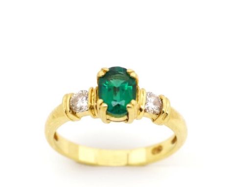 Synthetic emerald, diamond set yellow gold ring marked 750. Approx weight 3.7 grams, ring size M