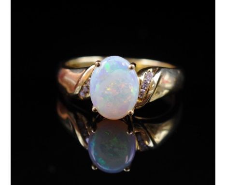 Opal, diamond set 18ct yellow gold ring marked 750. Approx weight 3.8 grams, ring size N