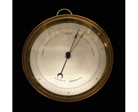 Brass cased aneroid barometer (diameter 12cm approx).