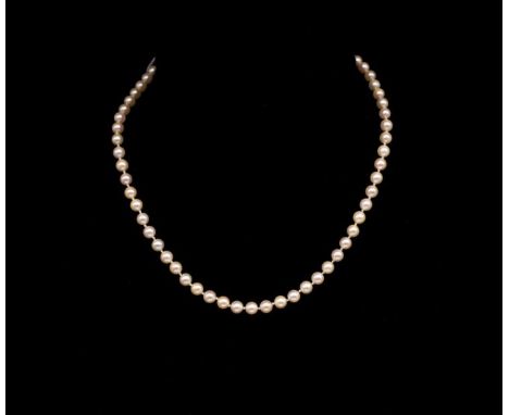Single strand pearl necklace and gold clasp the white gold flower form fish hook clasp is marked 18k Italy and set with a sin
