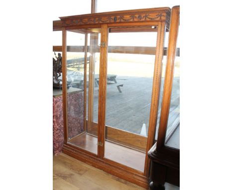 A 19TH CENTURY MAHOGANY GLAZED DISPLAY CABINET IN THE CHIPPENDALE STYLE, with carved swags and husks to the frieze, twin full