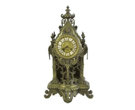 A BRASS CASED 19TH CENTURY ROCOCO STYLE MANTEL CLOCK, the ornately cast case having pierced fretwork and floral embellishment
