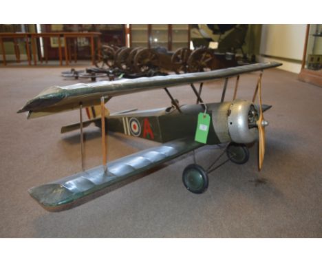 A SCALE MODEL OF A WWI SOPWITH CAMEL BIPLANE FIGHTER, painted in green and displaying RAF roundel, with aluminium engine shro