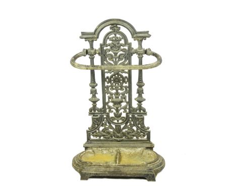 A 19TH CENTURY CAST IRON STICK STAND, unpainted, pierced floral decoration, break arch top and removable tray, H 71 cm, W 46 