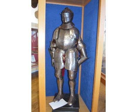 A 19TH CENTURY FULL SUIT OF PARADE ARMOUR WITH EARLIER COMPOSITIONS IN AN OAK BESPOKE CASTELLATED DISPLAY STAND, the armour o