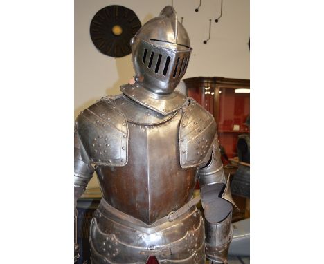 A FINE SUIT OF 16TH CENTURY ARMOUR WITH LATER ADDITIONS, comprising a close helmet, skull rising to a medial roped comb, pair