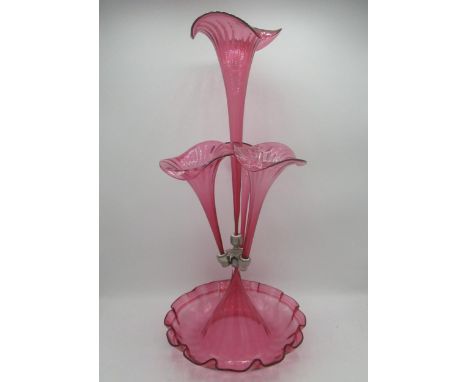 Victorian style cranberry glass epergne with four flutes on a scalloped edged circular base, H53cm 